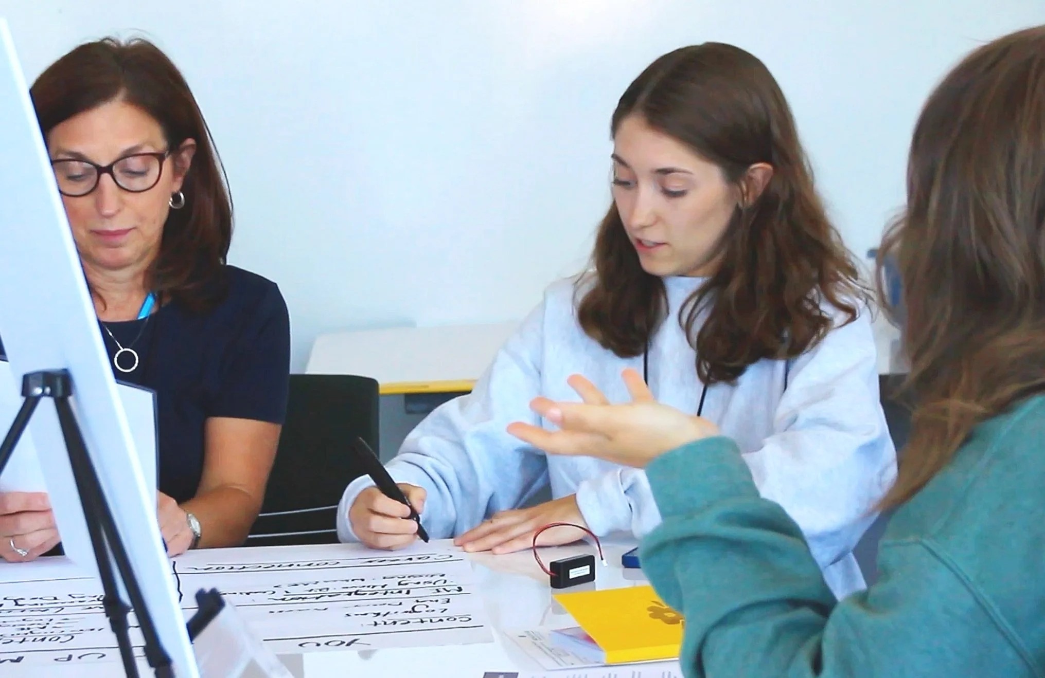 Roetker and Doyle brainstorming on chart paper