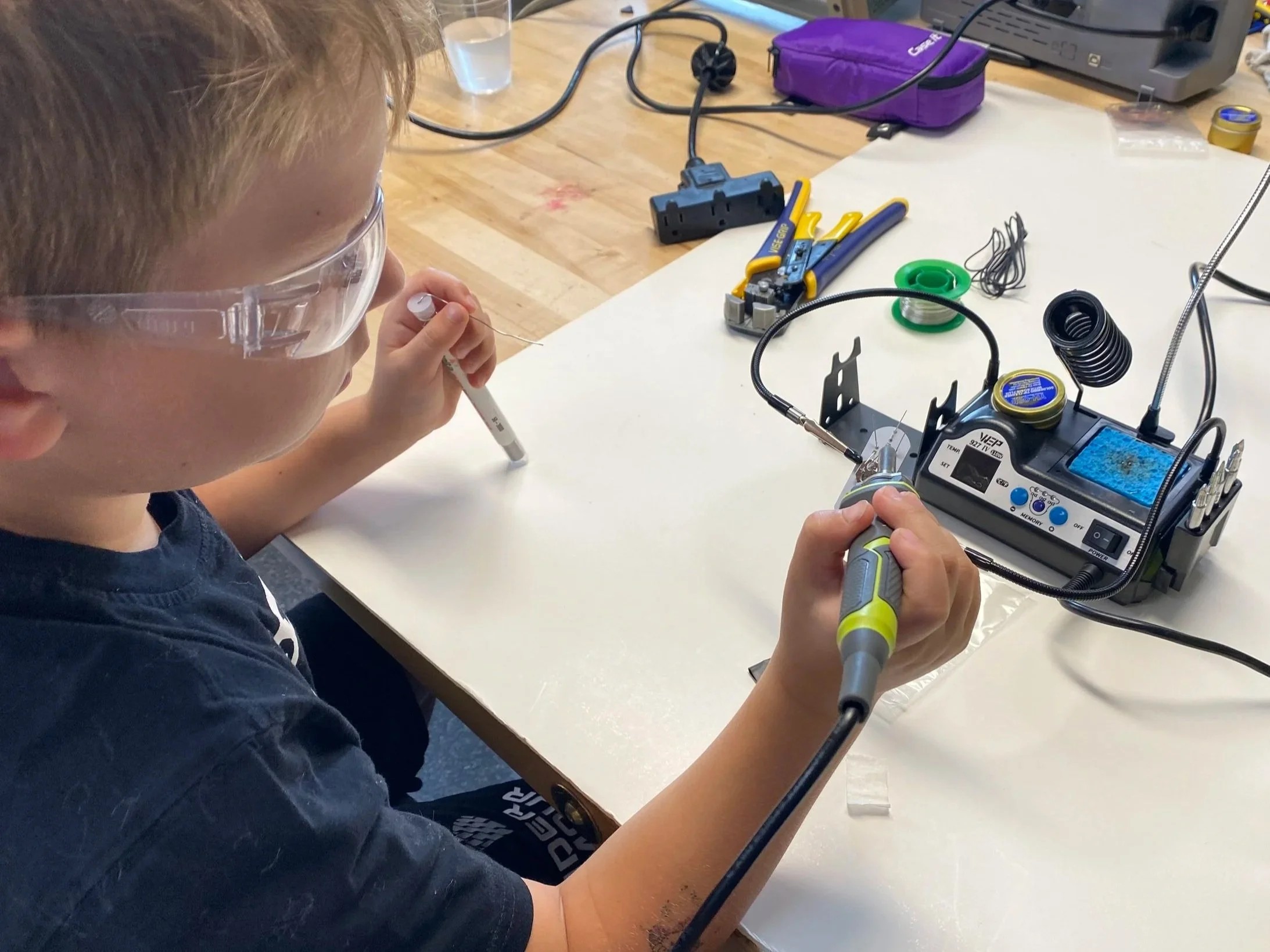 student working with soldering