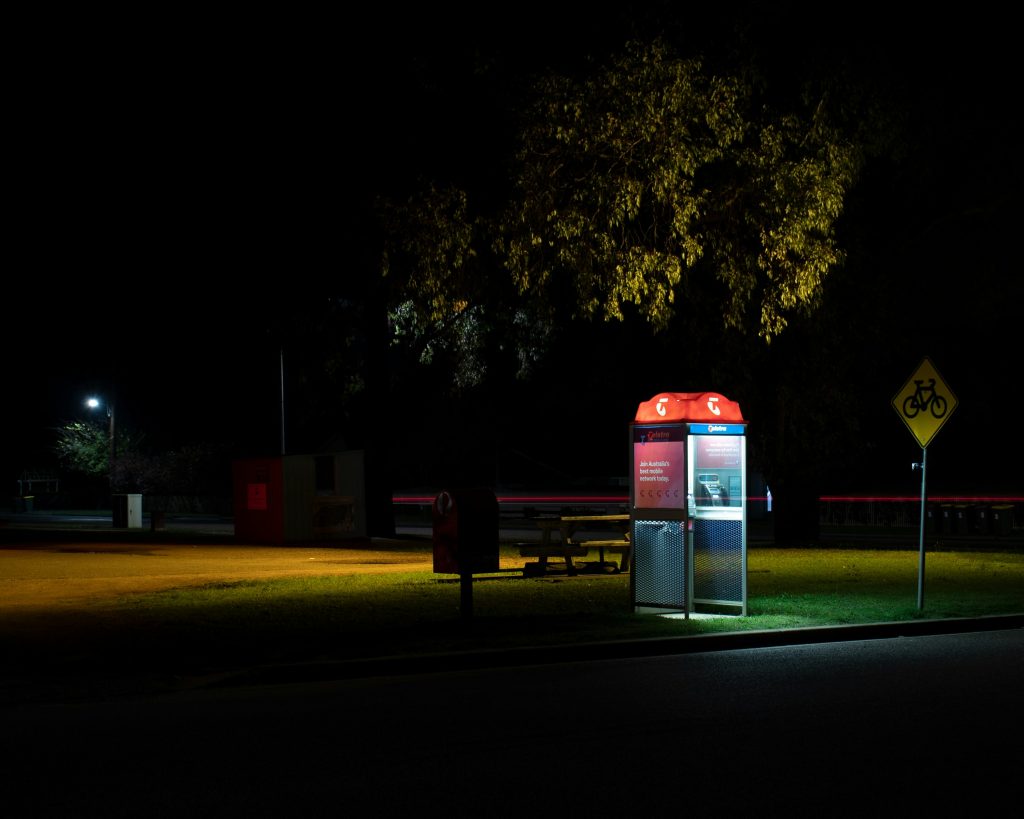 Telstra phone booth at night time