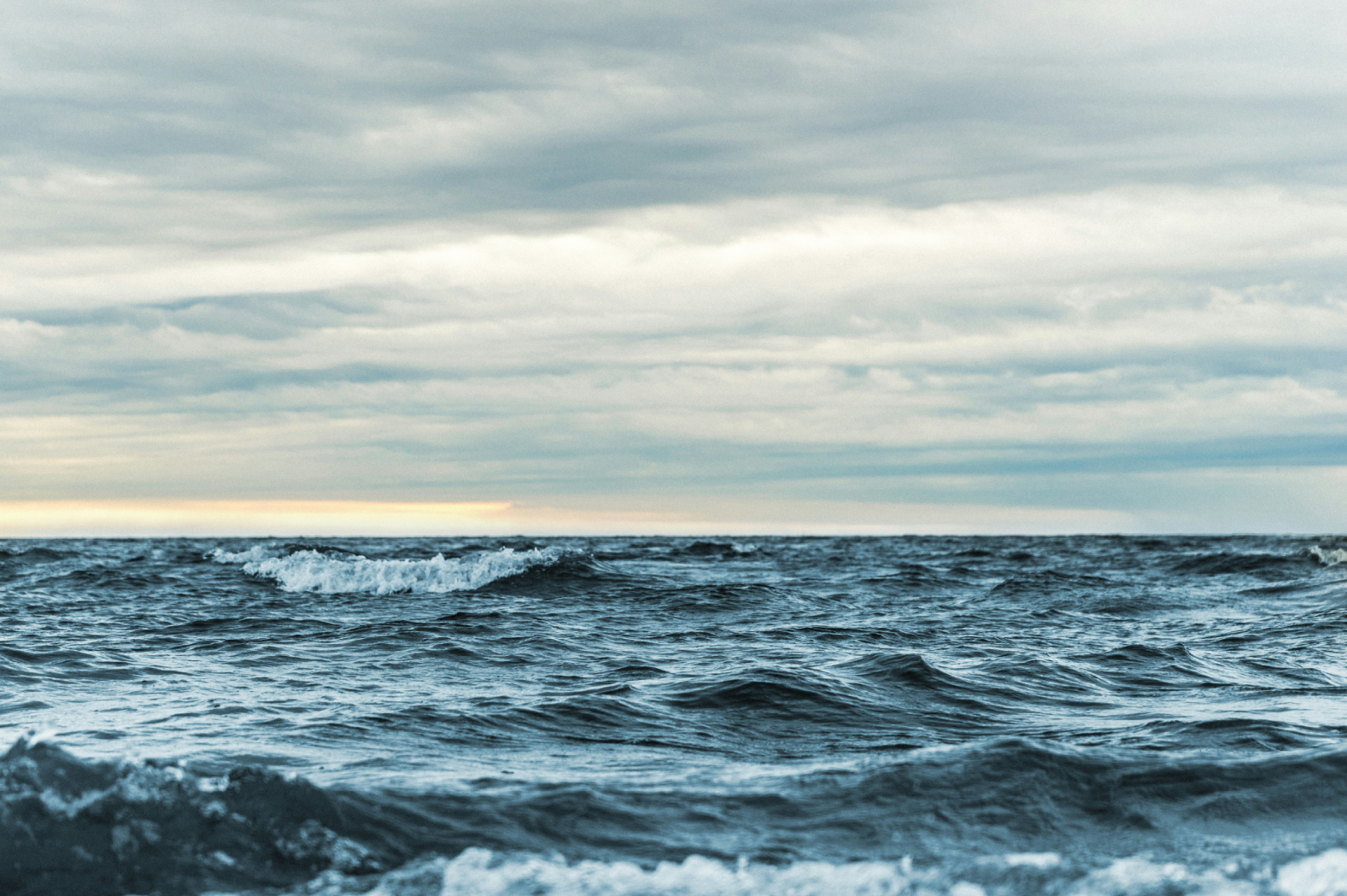 Dark ocean waves under a cloudy sky